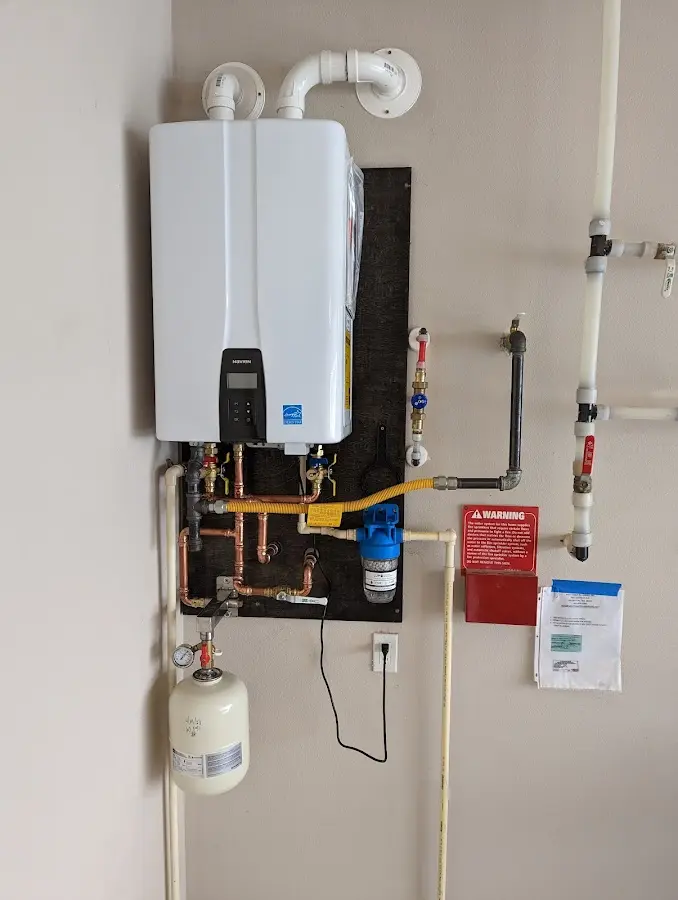 Professional plumber installing copper piping in a Loughman home